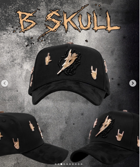 Black cap with a gold lightning bolt and gold rock hand-sign embroidery on the front and side panels.