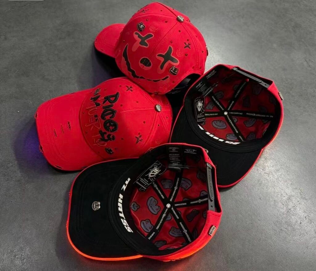 Set of red and black Rico Muerto caps shown with interiors visible, including the smiley lining print.